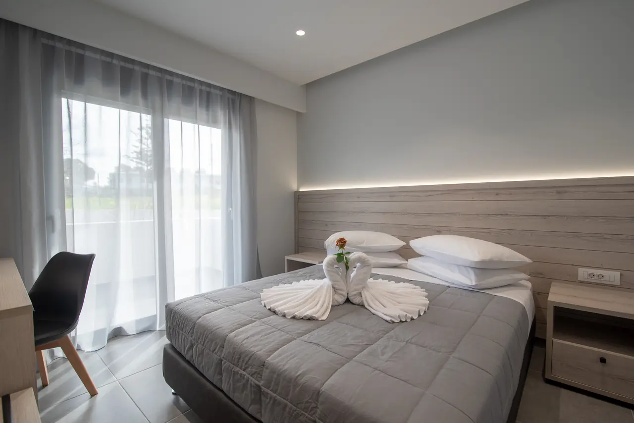 Bedroom with a queen-size bed and sheer curtains